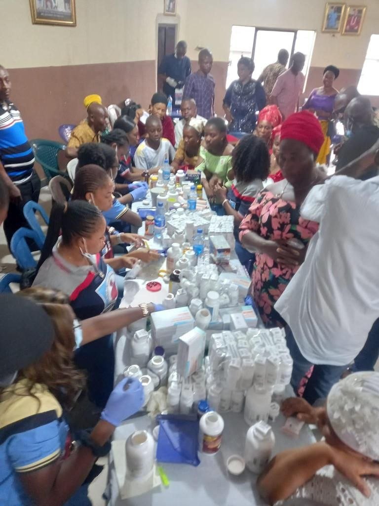 Volunteers distributing free medication to community members at a Living Grace Foundation medical mission